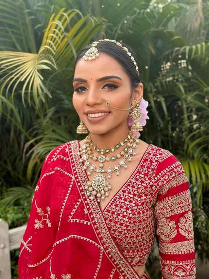 A closer portrait of the bride, highlighting the soft glam makeup that focuses on radiant skin and defined eyes, letting her natural beauty shine through.