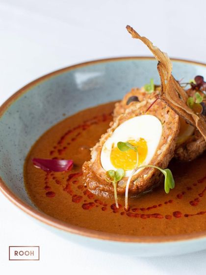 The Nargisi Chicken Kofta, sliced to reveal the beautiful egg center. It’s a visually stunning dish that delivers on flavour, garnished with a crispy potato wafer.