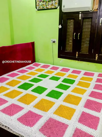 This bright and cheerful crochet bedsheet was made for a client's bedroom. The pattern uses solid granny squares for a modern, geometric look that is both warm and stylish.
