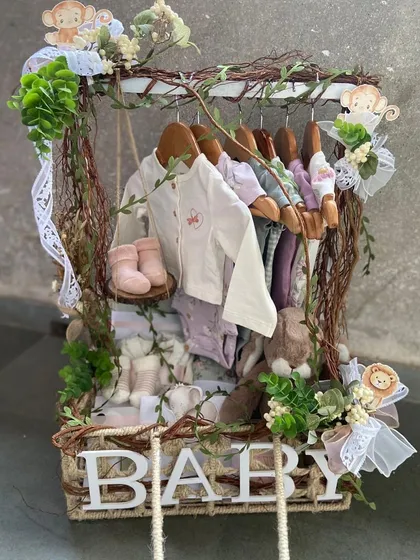 We redefine baby gifting with creative and enchanting concepts. This unique hamper, designed as a miniature wardrobe filled with adorable baby clothes and essentials, is a perfect example of how we turn a simple gift into a cherished and unforgettable keepsake.
