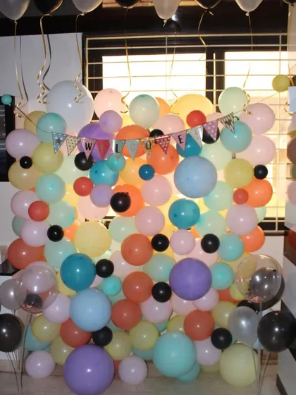 A full shot of the welcome balloon wall, perfect for taking group photos. The 'Welcome' banner is clearly visible amongst the colorful assortment of balloons.