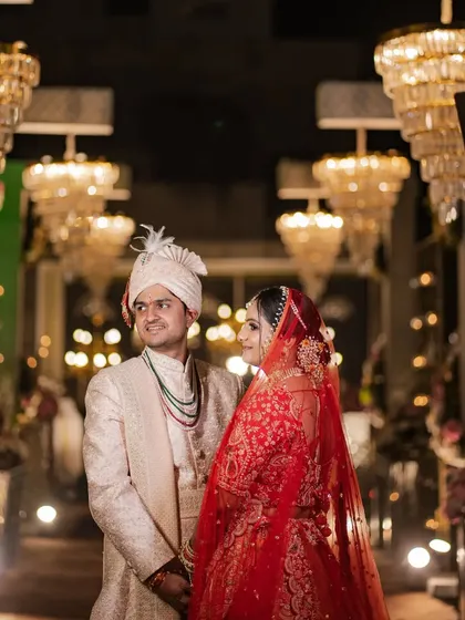 A look of love under the grand chandeliers. This portrait of Mehul and Saloni on their wedding day captures the opulence of their venue and the quiet connection between the couple.