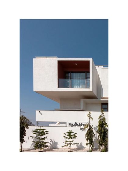 A detail of the Notan Home's facade, where a cantilevered volume creates a dramatic architectural statement. This element not only provides shade for the space below but also adds a sense of lightness and dynamism to the building's form.
