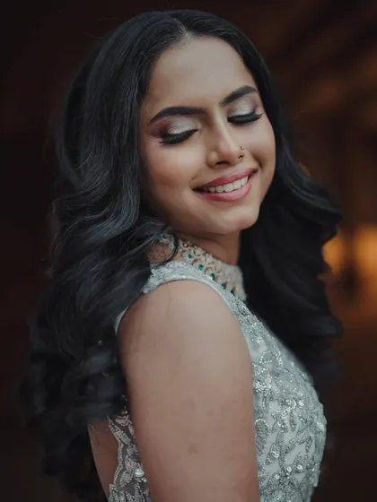 Glamorous, graceful, and glowing. This reception look features soft, voluminous curls and a shimmery eye, creating a romantic and classic vibe that is absolutely stunning.