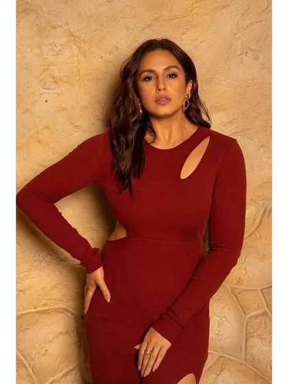 A confident pose in the red cutout dress, a perfect rental for someone who isn't afraid to be bold.