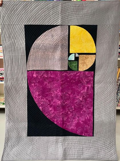 A magnificent art quilt depicting the Fibonacci spiral, a perfect marriage of math and art.