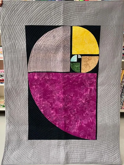 A magnificent art quilt depicting the Fibonacci spiral, a perfect marriage of math and art.