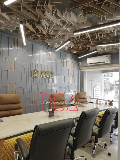 A wider angle of the StyleIn Homes conference room, showing the relationship between the meeting space and the rest of the office through the glass partition.