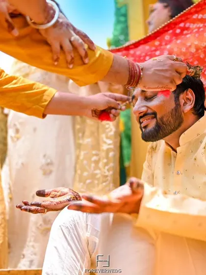 The traditional 'tilak' during the groom's Haldi ceremony. I focus on capturing the details of these important rituals, preserving the cultural significance of the wedding.