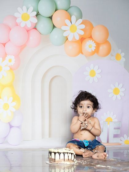 This little girl is getting right into her first birthday cake. These are the fun, candid moments I love to capture.