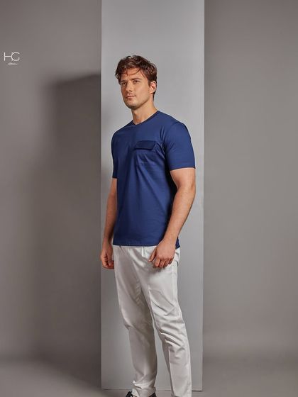 Another view of the premium navy t-shirt, showing its versatility and how it can be dressed up with tailored trousers for a smart, relaxed look.