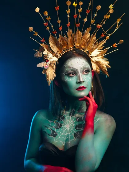 A fantasy creature look, combining body paint, intricate line work, and a stunning handmade headpiece.