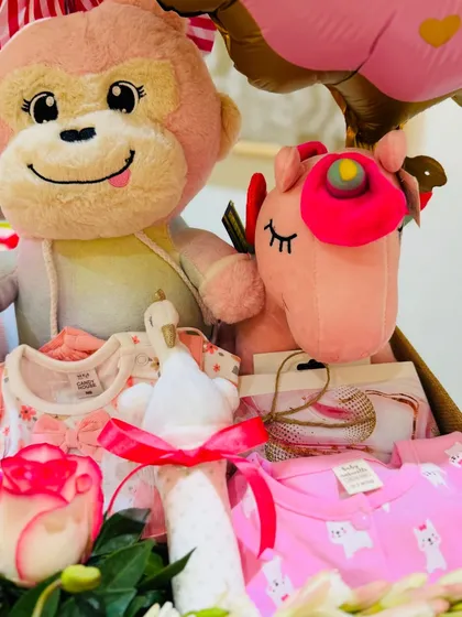 Another angle of the baby girl hamper, showing the soft toys and neatly folded outfits ready to be gifted.
