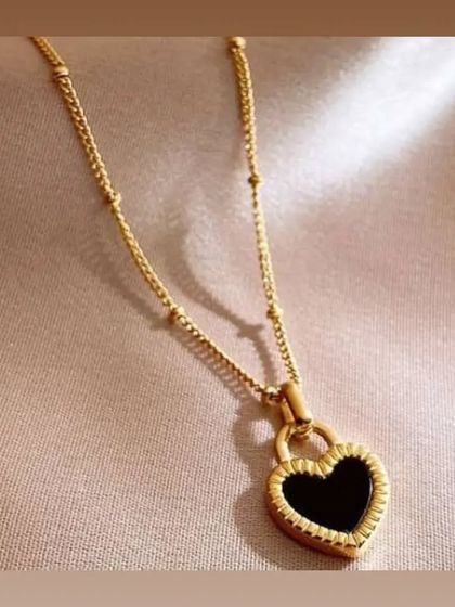 A beautiful heart-shaped padlock pendant with black enamel on a beaded satellite chain. This piece is both trendy and timeless.