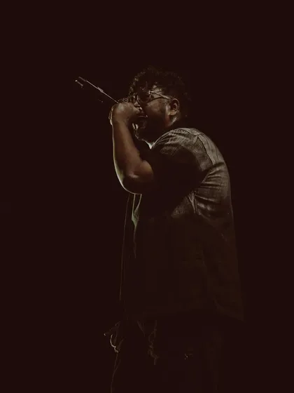 In my element, under the lights with the mic in my hand. This is where I speak my truth, one bar at a time, during an intense rap performance.