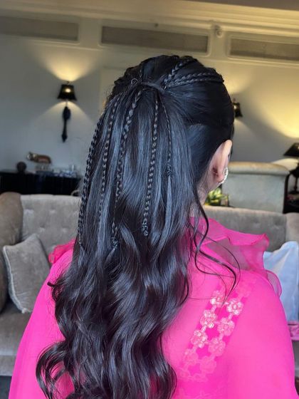 A back view of the ponytail with scattered thin braids. This adds texture and interest to a simple ponytail, a technique that is easy to learn and very effective.