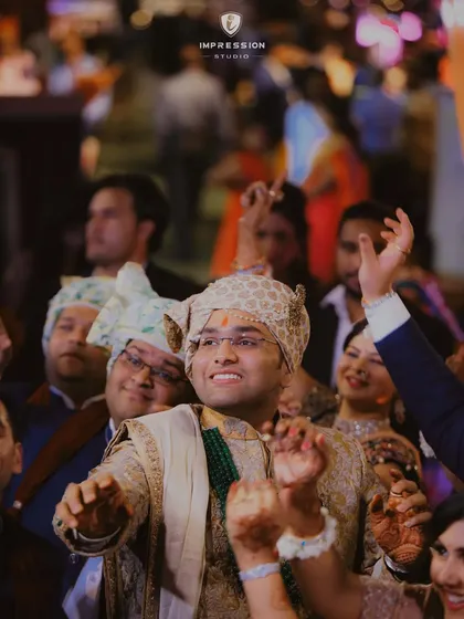 Capturing the rhythm of joy in every step. The groom, dancing into forever with sheer happiness, surrounded by his loved ones.