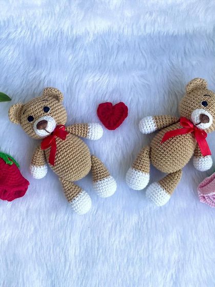 A pair of my classic teddy bears, each with a little red ribbon. These soft and cuddly bears are a timeless gift for all ages.