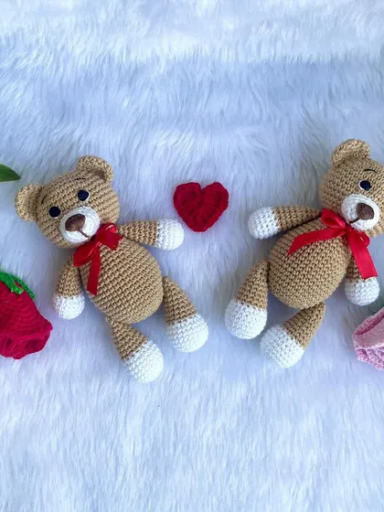 A classic teddy bear, a timeless gift for any age. This one is shown with a red ribbon, a black tie for 'Daddy Bear', and with expressive green eyes. They are soft, cuddly, and made to be loved.