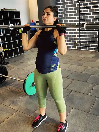 Getting ready to press. Proper starting position and core engagement are key to lifting safely and effectively. Weight training is a journey of learning how to control your body and the weight.