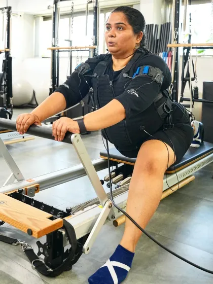 Sumukhi Suresh combines the EMS suit with a reformer machine. This innovative approach shows how we can integrate different equipment to create a unique, full body challenge.