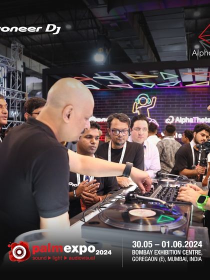 Interacting with attendees at the Pioneer DJ booth. I always make time to answer questions and share insights with anyone curious about the craft.