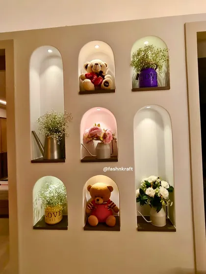 An adorable way to decorate for a baby's arrival. Wall niches are filled with teddy bears, small vases of baby's breath, and other cute floral arrangements, turning a simple wall into a lovely feature.