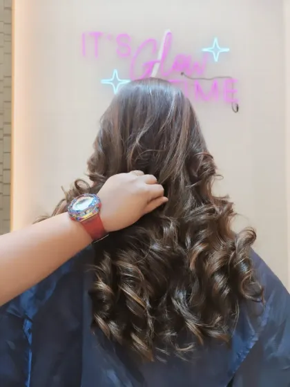 A close-up of these perfectly formed curls, showing off the subtle highlights that run through the hair. It's all about that glow.