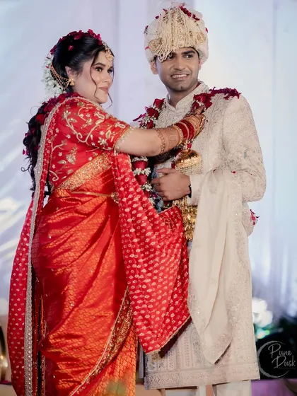 The varmala ceremony, a key ritual in Indian weddings. The bride looks absolutely stunning.