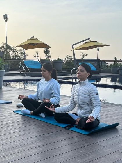 Meditating by the infinity pool. Our teachings are focused on helping you connect better with yourself.