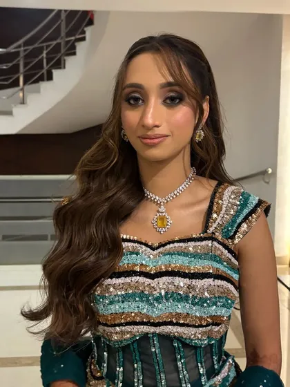 A close-up of the Sangeet hairstyle, showing the soft waves and trendy bangs that give this look a modern edge.