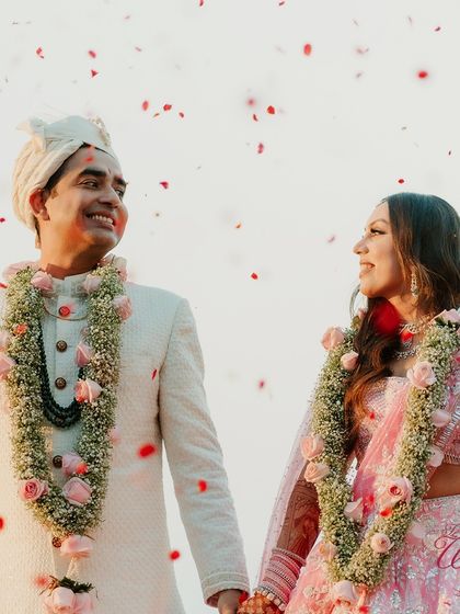 A close-up of the smiling bride and groom, their faces illuminated by the setting sun and their love.