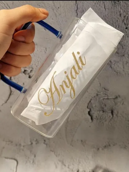 Holding our personalised square glass mug to show its unique shape and the elegant gold script for the name 'Anjali'.