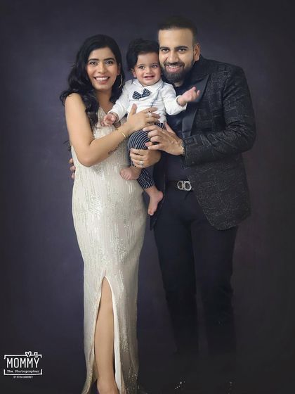 This stylish family looks so elegant in their coordinated outfits for a studio portrait session. A timeless way to capture your family at this stage.