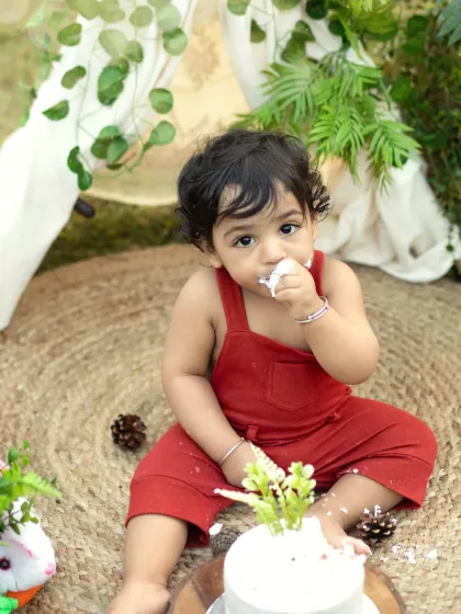 A sweet taste of cake during an outdoor jungle-themed shoot. The natural setting adds a beautiful, adventurous feel to this milestone session.