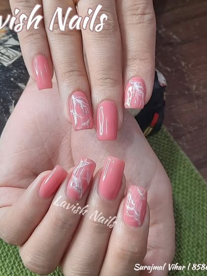 A lovely pink set with a white marble or quartz effect on the accent nails.