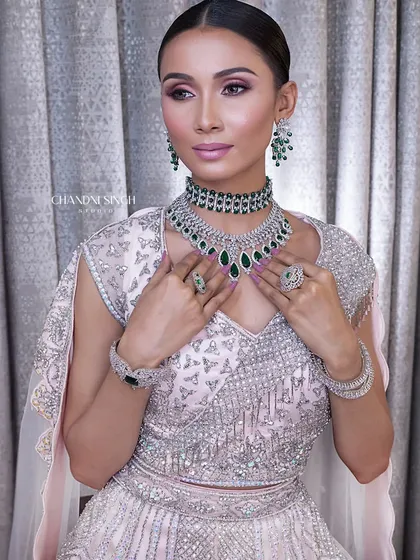 A soft glam look with a focus on pink and silver tones. The makeup is fresh and modern, with shimmery eyes and a subtle glow, perfect for a cocktail party or engagement.