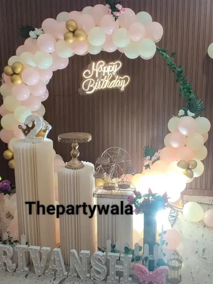 A simple and sweet ring decoration with pastel pink and gold balloons. The glittery silver name sign adds a touch of sparkle.