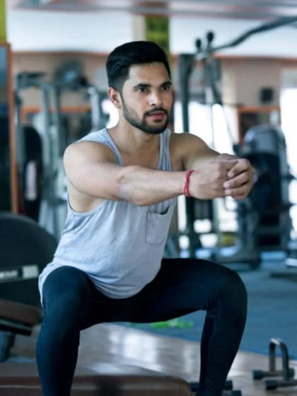 A client demonstrating a perfect bodyweight squat. Mastering this fundamental movement is crucial for long-term fitness.