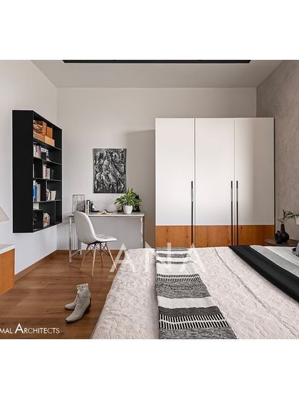 A view of the guest bedroom in Apartment 704, showing the sleek wardrobe and study nook. The design maximizes space while maintaining a clean, contemporary aesthetic.