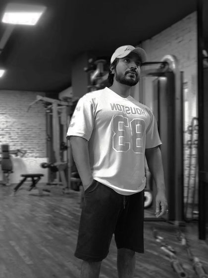 A moment of reflection in the gym. The black and white filter highlights the raw, focused atmosphere of a good workout space.