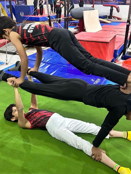Acrobatic gymnastics training builds trust, balance, and strength. Here, three of my students work together to create a multi-level balance pose, a great exercise for developing teamwork and body awareness.