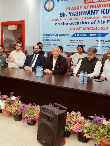 The Executive Committee seated on the dais during the farewell ceremony, honoring the service of a retiring judge.