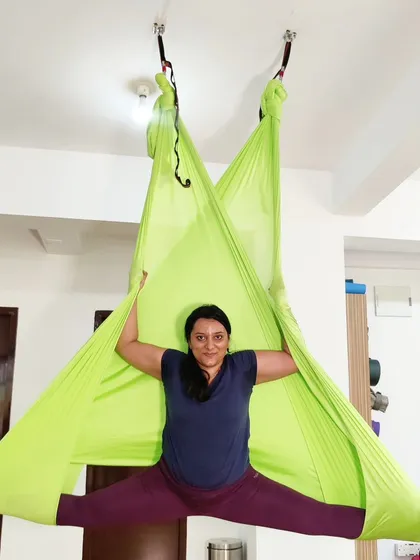 A duplicate of ID 76, this image shows a student enjoying the freedom and support of the aerial hammock during a split.