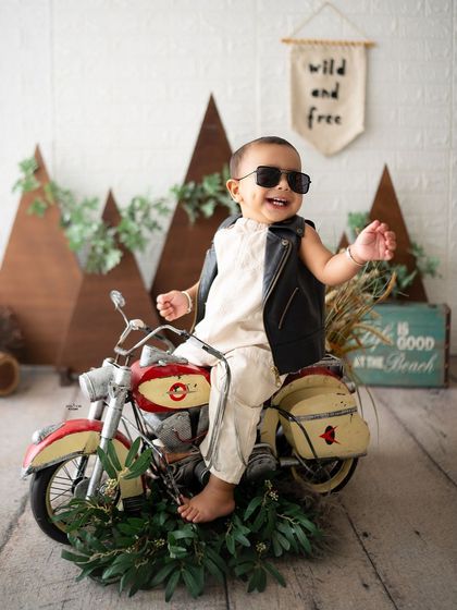 Wild and free! This little biker is having the time of his life on this cool miniature motorcycle.