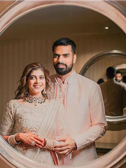 A beautiful mirror selfie of the couple, a modern twist on a classic portrait, reflecting their love story.