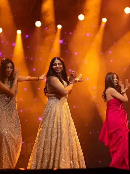 A graceful performance by the bride and her family members. The warm, golden lighting creates a beautiful atmosphere for this elegant dance.