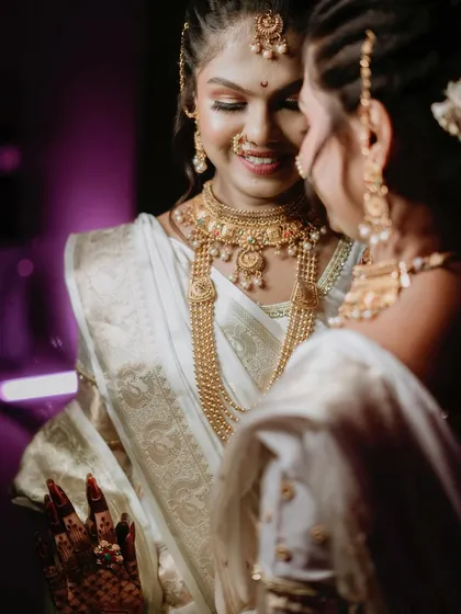 A quiet moment of reflection for the bride. This over-the-shoulder shot captures her looking at her reflection, a beautiful and intimate portrait before the ceremony begins.