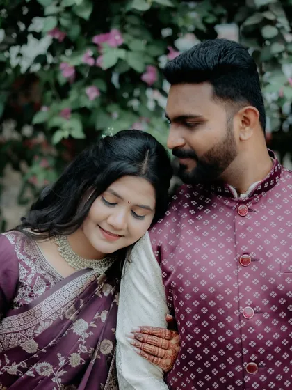 A tender moment with the bride-to-be resting her head on her partner's shoulder, full of love and trust.