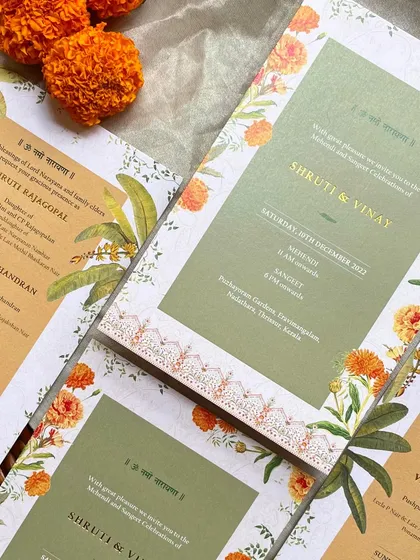 A closer look at the Mehendi and Sangeet invitation. The design features a traditional 'kolam'-style border, adding another layer of cultural authenticity to the stationery.